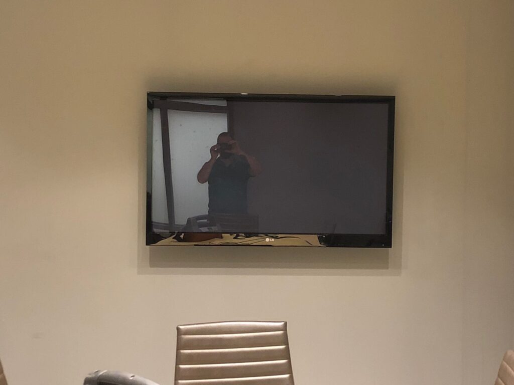 The original dated TV installed in the boardroom before it was revamped.